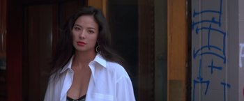 Movie still from “Rumble in the Bronx” (1995), directed by Stanley Tong – A woman wearing a white shirt and black lingerie; Close Up shot, Low angle