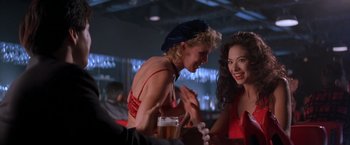 Movie still from “Rumble in the Bronx” (1995), directed by Stanley Tong – Two women sitting at a table talking to each other; Medium shot, Over the shoulder angle
