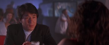Movie still from “Rumble in the Bronx” (1995), directed by Stanley Tong – A man sitting at a table in front of a woman; Close Up shot, Over the shoulder angle