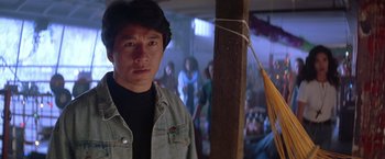 Movie still from “Rumble in the Bronx” (1995), directed by Stanley Tong – A man standing next to a wooden pole; Close Up shot, Low angle