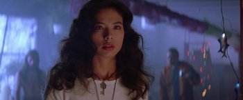Movie still from “Rumble in the Bronx” (1995), directed by Stanley Tong – A woman with long black hair wearing a white shirt; Close Up shot, Low angle