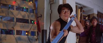 Movie still from “Rumble in the Bronx” (1995), directed by Stanley Tong – A man holding a blue object in his hands; Close Up shot, Low angle