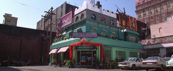 Movie still from “Rumble in the Bronx” (1995), directed by Stanley Tong – A building that has a lot of decorations on it; Wide shot, Low angle