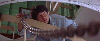 Movie still from “Rumble in the Bronx” (1995), directed by Stanley Tong – A man in a denim jacket looking at the camera; Close Up shot, Low angle