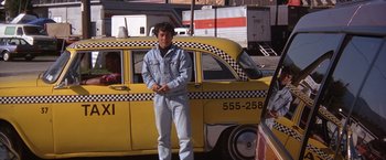 Movie still from “Rumble in the Bronx” (1995), directed by Stanley Tong – A man standing in front of a yellow taxi cab; Wide shot, Low angle