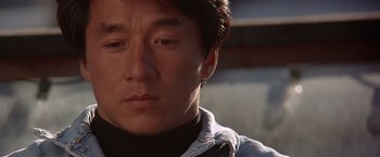 Movie still from “Rumble in the Bronx” (1995), directed by Stanley Tong – A person wearing a black shirt; Close Up shot, Low angle