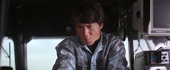 Movie still from “Rumble in the Bronx” (1995), directed by Stanley Tong – A man sitting in front of a window looking sad; Close Up shot, Low angle