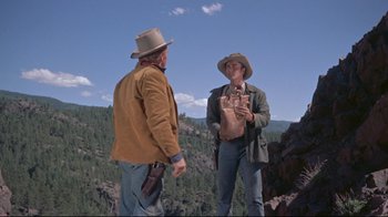 Movie still from “Run for Cover” (1955), directed by Nicholas Ray – Two men standing on a mountain side talking; Wide shot, Low angle