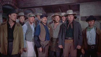Movie still from “Run for Cover” (1955), directed by Nicholas Ray – A group of men standing next to each other wearing cowboy hats; Medium shot, Low angle