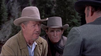 Movie still from “Run for Cover” (1955), directed by Nicholas Ray – Two men in cowboy hats are talking to each other; Medium shot, Over the shoulder angle