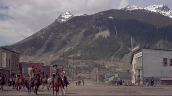 Movie still from “Run for Cover” (1955), directed by Nicholas Ray – A group of people riding horses on a dirt road; Extreme Wide shot, Low angle