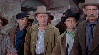 Movie still from “Run for Cover” (1955), directed by Nicholas Ray – A group of men standing next to each other wearing cowboy hats; Medium shot, Low angle
