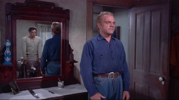 Movie still from “Run for Cover” (1955), directed by Nicholas Ray – An older man standing in front of a bathroom mirror; Medium shot, Low angle