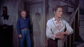 Movie still from “Run for Cover” (1955), directed by Nicholas Ray – A man and a woman standing next to each other in a room; Medium shot, Low angle