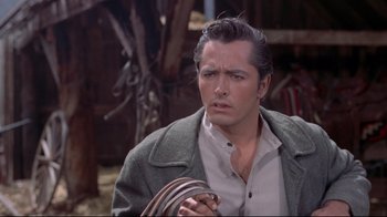 Movie still from “Run for Cover” (1955), directed by Nicholas Ray – A person wearing a suit and tie; Close Up shot, Over the shoulder angle