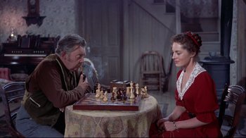 Movie still from “Run for Cover” (1955), directed by Nicholas Ray – A man and a woman playing a game of chess; Medium shot, High angle