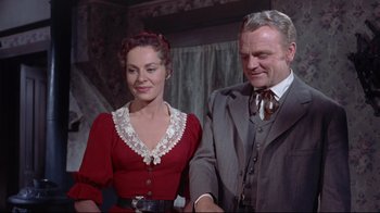 Movie still from “Run for Cover” (1955), directed by Nicholas Ray – An older man and a younger woman standing next to each other; Medium shot, Low angle