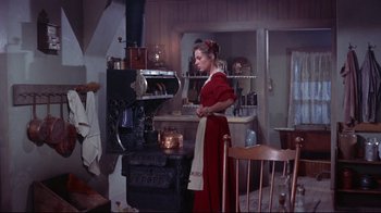 Movie still from “Run for Cover” (1955), directed by Nicholas Ray – A woman standing in front of an old fashioned stove; Wide shot, High angle