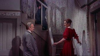 Movie still from “Run for Cover” (1955), directed by Nicholas Ray – A man and a woman standing on a set of stairs; Wide shot, Low angle