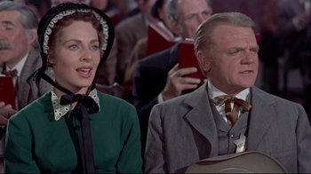 Movie still from “Run for Cover” (1955), directed by Nicholas Ray – A man and a woman sitting next to each other; Medium shot, Low angle