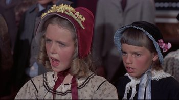 Movie still from “Run for Cover” (1955), directed by Nicholas Ray – Two young children in period costumes singing in front of a group of people; Close Up shot, High angle