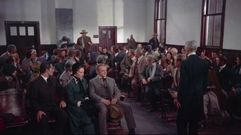 Movie still from “Run for Cover” (1955), directed by Nicholas Ray – A group of people sitting in a room; Wide shot, High angle