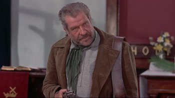 Movie still from “Run for Cover” (1955), directed by Nicholas Ray – An older man holding a camera and wearing a brown jacket; Medium shot, Over the shoulder angle