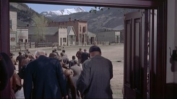 Movie still from “Run for Cover” (1955), directed by Nicholas Ray – A group of people walking on a dirt road; Extreme Wide shot, High angle