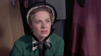 Movie still from “Run for Cover” (1955), directed by Nicholas Ray – A woman wearing a green dress and a black hat; Close Up shot, Over the shoulder angle