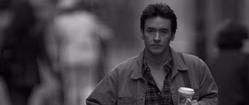 Movie still from “Runaway Jury” (2003), directed by Gary Fleder – Black and white photograph of a man in a plaid shirt; Close Up shot, Low angle