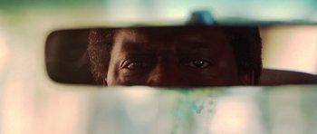 Movie still from “Runaway Jury” (2003), directed by Gary Fleder – A man's eyes looking through a window; Extreme Close Up shot, Low angle