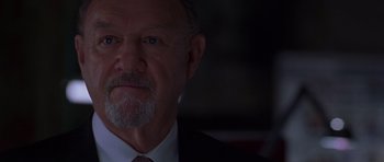 Movie still from “Runaway Jury” (2003), directed by Gary Fleder – An older man wearing a white shirt and a red tie; Close Up shot, Low angle