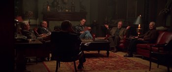 Movie still from “Runaway Jury” (2003), directed by Gary Fleder – A group of people sitting around a living room; Wide shot, High angle