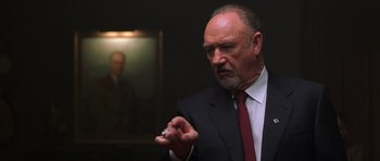 Movie still from “Runaway Jury” (2003), directed by Gary Fleder – An older man wearing a suit and tie holding a cigarette; Close Up shot, Low angle