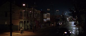 Movie still from “Runaway Jury” (2003), directed by Gary Fleder – A city street at night lit up by streetlights; Extreme Wide shot, High angle