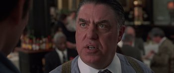 Movie still from “Runaway Jury” (2003), directed by Gary Fleder – An older man in a suit and tie looking at the camera; Close Up shot, Low angle