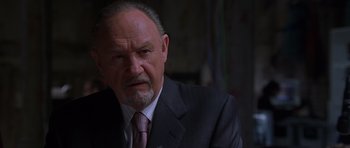 Movie still from “Runaway Jury” (2003), directed by Gary Fleder – An older man wearing a suit and tie; Close Up shot, Low angle