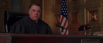 Movie still from “Runaway Jury” (2003), directed by Gary Fleder – A man in a court room wearing a judge's robe; Close Up shot, Low angle