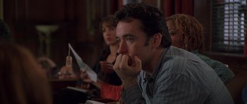 Movie still from “Runaway Jury” (2003), directed by Gary Fleder – A man sitting in front of a group of other people; Close Up shot, Over the shoulder angle