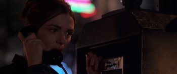 Movie still from “Runaway Jury” (2003), directed by Gary Fleder – A woman is talking on a phone in a dark room; Close Up shot, Low angle