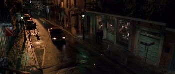 Movie still from “Runaway Jury” (2003), directed by Gary Fleder – A car parked on the side of the street at night; Extreme Wide shot, High angle