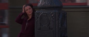 Movie still from “Runaway Jury” (2003), directed by Gary Fleder – A woman standing in front of an ornate metal object; Medium shot, High angle