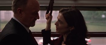 Movie still from “Runaway Jury” (2003), directed by Gary Fleder – A man and a woman face to face on a bus; Close Up shot, Over the shoulder angle