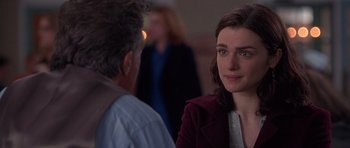 Movie still from “Runaway Jury” (2003), directed by Gary Fleder – A woman is talking to a man in front of another man; Close Up shot, Over the shoulder angle