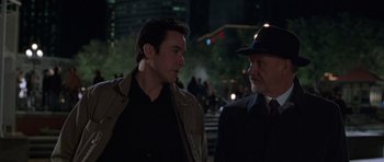 Movie still from “Runaway Jury” (2003), directed by Gary Fleder – A man in a hat and a man in a suit talking to each other; Close Up shot, Over the shoulder angle