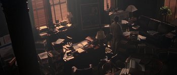 Movie still from “Runaway Jury” (2003), directed by Gary Fleder – A man standing in a room with many papers on the floor; Wide shot, High angle