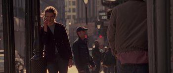 Movie still from “Runaway Jury” (2003), directed by Gary Fleder – A group of people walking down a street; Medium shot, Over the shoulder angle