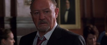 Movie still from “Runaway Jury” (2003), directed by Gary Fleder – An older man wearing a suit and a tie; Close Up shot, Low angle