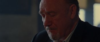 Movie still from “Runaway Jury” (2003), directed by Gary Fleder – An older man in a suit looking down at his face; Close Up shot, Low angle