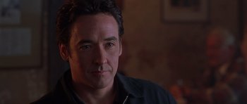 Movie still from “Runaway Jury” (2003), directed by Gary Fleder – A person wearing a black shirt; Close Up shot, Over the shoulder angle